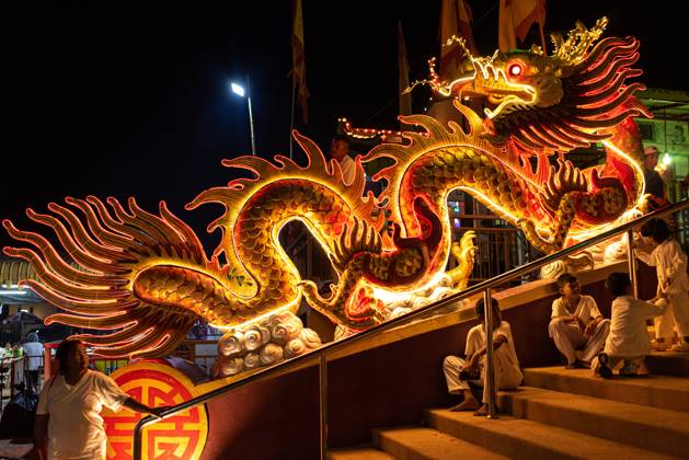 The vegetarian festival in Trang, Thailand. – 13 Oct 2026 Devotees sit next to the illuminated dragon at the Chinese shrine during the Vegetarian Festival. The annual Vegetarian Festival is held in Bangkok and many parts of southern Thailand, including Trang, Phatthalung, and Phuket, where worshippers refrain from eating animal products over the nine days, coinciding with the celebration of the Nine Emperor Gods. Trang Thailand Copyright: xPeeraponxBoonyakiatx xSOPAxImagesx Peerapon-Boonyakiat-1458504