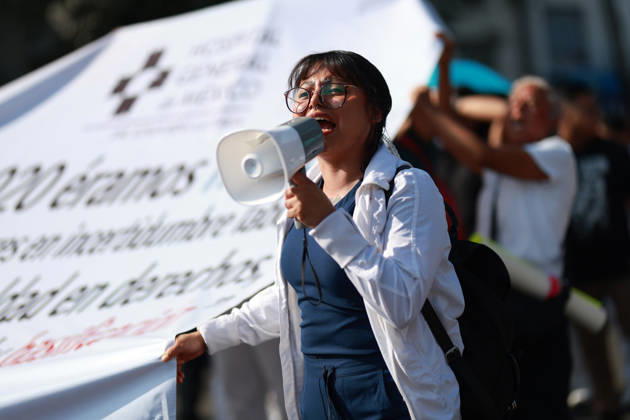 Thousands of healthcare workers hold national protest in Mexico City MEXICO CITY, MEXICO - OCTOBER 13: A woman takes part in a national protest march demanding wage increases for healthcare workers and more medical supplies for Mexico s public health system, in Mexico City, Mexico on October 13, 2026. Thousands of members of the Mexican Social Security Institute (IMSS) marched to demand higher wages, improved working conditions, and action to address nationwide shortages of basic medicines and supplies across public hospitals. Daniel Cardenas Anadolu Mexico City Mexico. Editorial use only. Please get in touch for any other usage.  Copyright: x2026xAnadoluxDanielxCardenasx