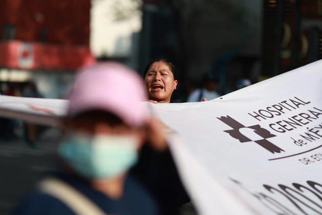 Thousands of healthcare workers hold national protest in Mexico City MEXICO CITY, MEXICO - OCTOBER 13: A woman takes part in a national protest march demanding wage increases for healthcare workers and more medical supplies for Mexico s public health system, in Mexico City, Mexico on October 13, 2026. Thousands of members of the Mexican Social Security Institute (IMSS) marched to demand higher wages, improved working conditions, and action to address nationwide shortages of basic medicines and supplies across public hospitals. Daniel Cardenas Anadolu Mexico City Mexico. Editorial use only. Please get in touch for any other usage.  Copyright: x2026xAnadoluxDanielxCardenasx