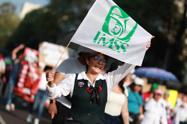 Thousands of healthcare workers hold national protest in Mexico City MEXICO CITY, MEXICO - OCTOBER 13: A woman takes part in a national protest march demanding wage increases for healthcare workers and more medical supplies for Mexico s public health system, in Mexico City, Mexico on October 13, 2026. Thousands of members of the Mexican Social Security Institute (IMSS) marched to demand higher wages, improved working conditions, and action to address nationwide shortages of basic medicines and supplies across public hospitals. Daniel Cardenas Anadolu Mexico City Mexico. Editorial use only. Please get in touch for any other usage.  Copyright: x2026xAnadoluxDanielxCardenasx