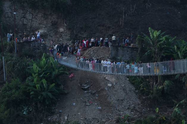 October 14, 2026, Nuwakot, Nepal: NUWAKOT, NEPAL, OCTOBER 14, 2026: Residents cross a newly built suspension bridge over the Trishuli River in Nuwakot, restoring access between communities affected by flash floods. Flooding destroyed bridges and damaged roads in the district, disrupting travel and access to essential services. Nuwakot Nepal  - ZUMAq101 20261014_zna_q101_128 Copyright: xShankarxBhujelx