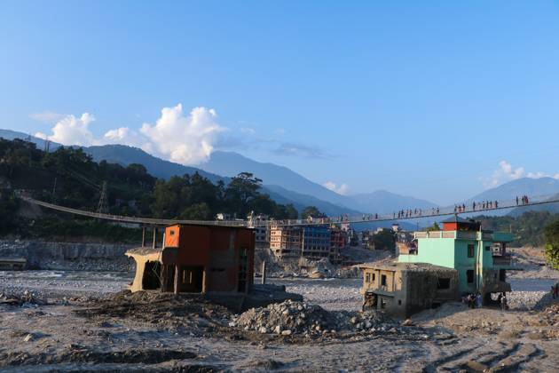 October 14, 2026, Nuwakot, Nepal: NUWAKOT, NEPAL, OCTOBER 14, 2026: Residents cross a newly built suspension bridge over the Trishuli River in Nuwakot, restoring access between communities affected by flash floods. Flooding destroyed bridges and damaged roads in the district, disrupting travel and access to essential services. Nuwakot Nepal  - ZUMAq101 20261014_zna_q101_131 Copyright: xShankarxBhujelx
