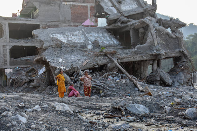 Aftermath of flash floods in Nepal NUWAKOT, NEPAL - OCTOBER 14 : Women inspect the area near a house damaged by flash floods in Trishuli, Nuwakot district, Nepal on October 14, 2026. Road and pedestrian connectivity has been restored with the construction of a new suspension bridge over the Trishuli River, allowing local residents to cross the river after the devastating floods damaged bridges and other infrastructure in the area. Sunil Pradhan Anadolu Nuwakot Nepal. Editorial use only. Please get in touch for any other usage.  Copyright: x2026xAnadoluxSunilxPradhanx