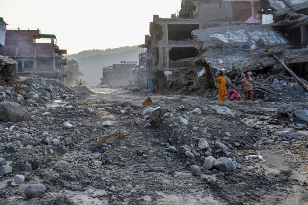 Aftermath of flash floods in Nepal NUWAKOT, NEPAL - OCTOBER 14 : Women inspect the area near a house damaged by flash floods in Trishuli, Nuwakot district, Nepal on October 14, 2026. Road and pedestrian connectivity has been restored with the construction of a new suspension bridge over the Trishuli River, allowing local residents to cross the river after the devastating floods damaged bridges and other infrastructure in the area. Sunil Pradhan Anadolu Nuwakot Nepal. Editorial use only. Please get in touch for any other usage.  Copyright: x2026xAnadoluxSunilxPradhanx
