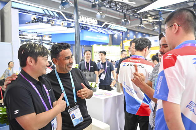 GUANGZHOU, CHINA - OCTOBER 15: Zhang Xue (L) poses for a photo with an overseas buyer at the booth of Chinese motorcycle brand Zhangxue Motorcycle (ZXMOTO) during the 140th China Import and Export Fair (Canton Fair) on October 15, 2026 in Guangzhou, Guangdong Province of China. The fair runs in three phases until November 4, covering a total exhibition area of 1.55 million square meters.  Copyright: xChinaxNewsxServicex 111674432479