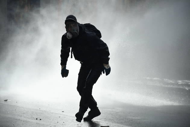 Student protests demanding improved educational conditions continue in Albania TIRANA, ALBANIA - OCTOBER 15: A protester, wearing a gas mask, moves through a cloud of water sprayed by a police water cannon during the third day of demonstrations demanding improved educational conditions in Tirana, Albania, on October 15, 2026. University students are joined by high school students and local residents as tensions escalate, with police using tear gas to disperse demonstrators outside the Ministry of Education and the Parliament building, while protesters throw stones and other objects at police officers. Olsi Shehu Anadolu Tirana Albania. Editorial use only. Please get in touch for any other usage.  Copyright: x2026xAnadoluxOlsixShehux
