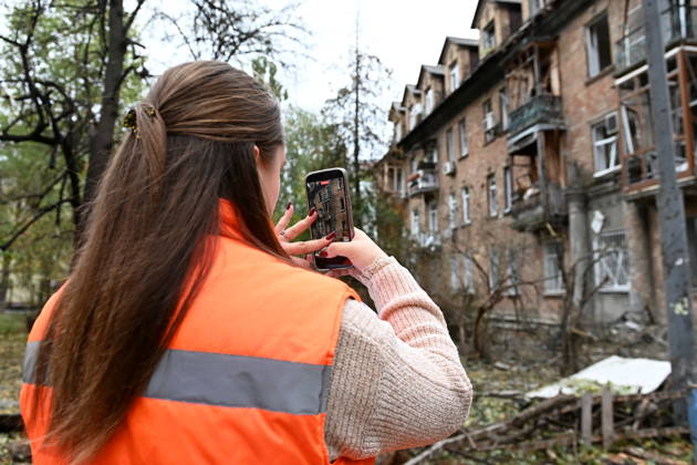 Aftermath Of A Russian Drone Attack In Kyiv, 15 Oct 2026 A woman photographs a damaged residential building following an explosion caused by a Geran-5 jet-powered drone in Kyiv, Ukraine, on October 15, 2026. Kyiv Ukraine  Copyright: xOleksandrxGusevx originalFilename: gusev-notitle261015_npS9x.jpg