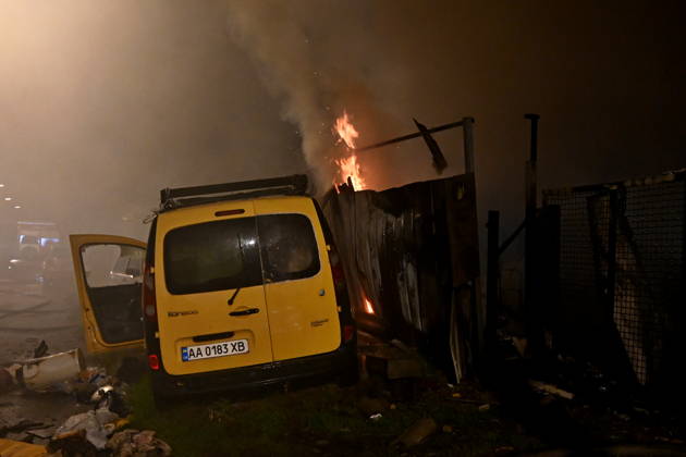 Russian Drone Attack On Kyiv, Ukraine Fire is visible near a damaged car at the scene of a blaze at a private residential house in the Shevchenkivskyi district of Kyiv, Ukraine, on October 15, 2026, following an explosion caused by a jet-powered drone launched by Russia. Kyiv Ukraine  Copyright: xOleksandrxGusevx originalFilename: gusev-notitle261015_npE8p.jpg