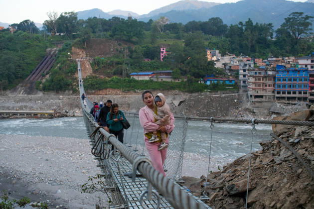 NUWAKOT, NEPAL - OCTOBER 15: Local residents walk on the newly installed Bailey bridge connecting the border areas of Nuwakot and Rasuwa districts on October 15, 2026 in Nuwakot, Nepal. The bridge was installed to restore road connectivity after severe flooding destroyed existing bridges on August 26, 2026.  Copyright: xChinaxNewsxServicex 111674496531