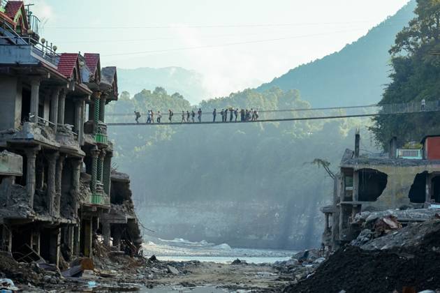New Bridge Restores Nuwakot Crossing NUWAKOT, NEPAL, OCTOBER 15, 2026: People cross a newly built suspension bridge over the Trishuli River in Bidur Municipality, Nuwakot District. The footbridge restores access between communities after flooding along the Bhotekoshi Trishuli river corridor swept away road bridges and disrupted local transport. NUWAKOT bagmati Nepal Copyright: x xAmbirxTolangx xJNAxPressx