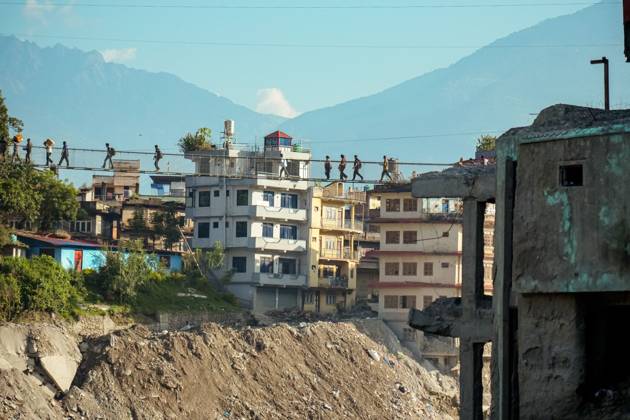 New Bridge Restores Nuwakot Crossing NUWAKOT, NEPAL, OCTOBER 15, 2026: People cross a newly built suspension bridge over the Trishuli River in Bidur Municipality, Nuwakot District. The footbridge restores access between communities after flooding along the Bhotekoshi Trishuli river corridor swept away road bridges and disrupted local transport. NUWAKOT bagmati Nepal Copyright: x xAmbirxTolangx xJNAxPressx