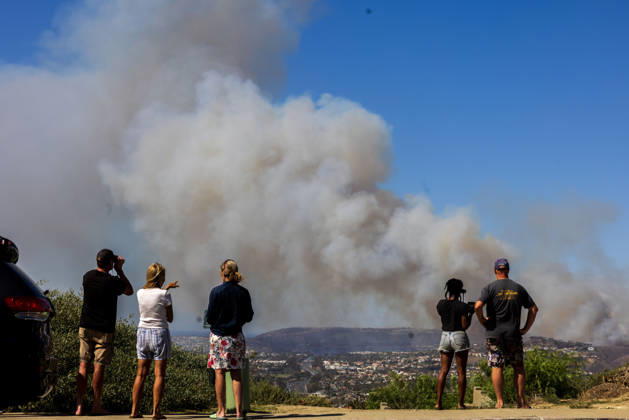 October16, 2026, San Juan Capistrano, California, USA: Fire crews are aggressively battling a wind-driven brush fire that burned several homes and threatened thousands of others in the area of San Juan Capistrano and San Clemente Friday, prompting evacuation orders. The Norte Fire exploded to 465 acres and remains 0 percent contained as of 4 p.m. O.C. Fire Authority officials said the Norte Fire started around 11:30 a.m. near Portico Del Norte and Eminencia Del Norte in San Clemente, east of Interstate 5. Fueled by strong Santa Ana winds, the wildfire then blew into neighboring San Juan Capistrano. San Juan Capistrano USA - ZUMAr19_ 20261016_new_r19_163 Copyright: xRuaridhxStewartx