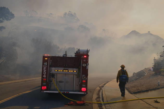October16, 2026, San Juan Capistrano, California, USA: Fire crews are aggressively battling a wind-driven brush fire that burned several homes and threatened thousands of others in the area of San Juan Capistrano and San Clemente Friday, prompting evacuation orders. The Norte Fire exploded to 465 acres and remains 0 percent contained as of 4 p.m. O.C. Fire Authority officials said the Norte Fire started around 11:30 a.m. near Portico Del Norte and Eminencia Del Norte in San Clemente, east of Interstate 5. Fueled by strong Santa Ana winds, the wildfire then blew into neighboring San Juan Capistrano. San Juan Capistrano USA - ZUMAr19_ 20261016_new_r19_191 Copyright: xRuaridhxStewartx