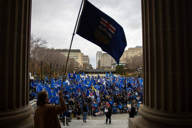 October 17, 2026, Edmonton, Ab, Canada: An attendee waves the Alberta flag at the crowd during an Alberta independence rally at the Alberta legislature, in Edmonton on Saturday, Oct. 17, 2026. Edmonton Canada  - ZUMAc35_ 20261017_zaf_c35_038 Copyright: xAmandaxMayxEricksonx