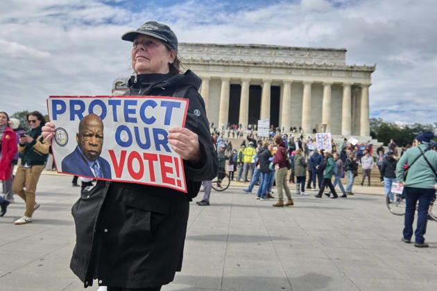 October 17, 2026, Washington Dc, Washington Dc, USA: A No Kings holds a sign of late civil rights activist and US Rep. John Lewis during rally at the steps of the Lincoln Memorial in Washington DC, Oct. 17, 2026. The march, intended to encourage people to vote in the 2026 US midterm elections, was part of a 50-state get out the vote operation by the left-leaning Indivisible group. Protesters denounced the administration of US President Donald Trump and the Republican-led Congress for violating Constitutional and civil rights, federal and state laws, judicial orders and longstanding norms, casting Trump and the GOP as a threat to democracy. Washington Dc USA - ZUMAg216 20261017_znp_g216_018 Copyright: xDominicxGwinnx
