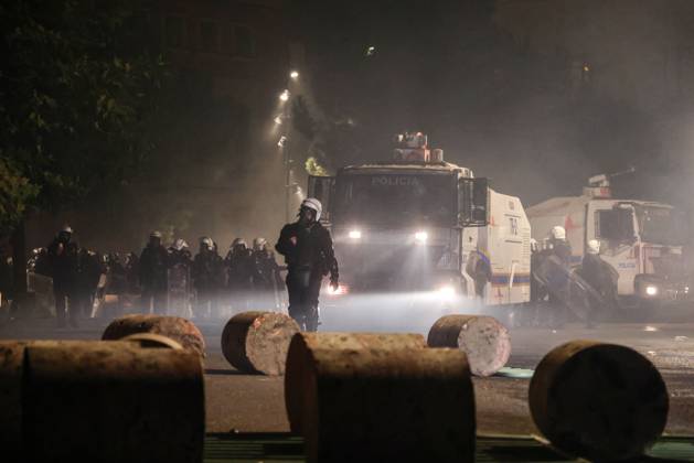 October 18, 2026, Tirana, Albania: TIRANA, ALBANIA, OCTOBER 18, 2026: Demonstrators clash with riot police in Skanderbeg Square as student-led anti-government protests continue for a sixth consecutive day. Confrontations spread from the Ministry of Education to central Tirana, with protesters throwing stones and pyrotechnics while police deploy tear gas and water cannons. Demonstrators demand improved university conditions and the resignation of Prime Minister Edi Rama. Tirana Albania  - ZUMAq101 20261018_zna_q101_226 Copyright: xVlasovxSulajx