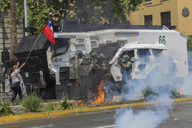 October 19, 2026, Santiago, Chile: A Molotov cocktail bomb falls on the feet of special forces police officers. In the center of the capital of Chile, different incidents took place between demonstrators and the police. The riots were carried out during the commemoration of the 7 years after the social outcast that happened on October 18, 2019. Santiago Chile - ZUMAs197 20261019_aaa_s197_014 Copyright: xSebastianxNancox
