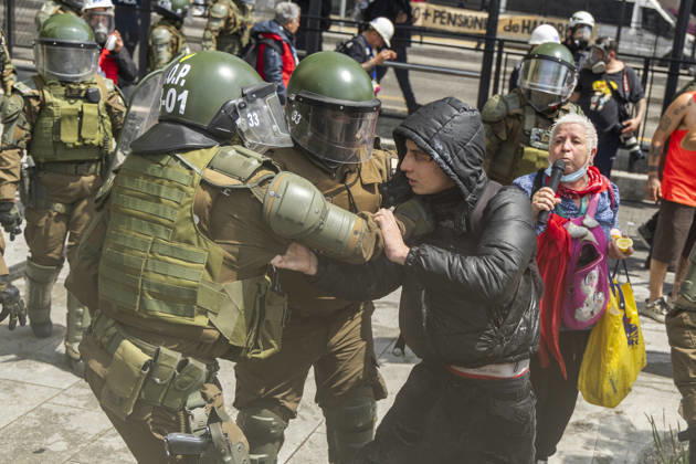 October 19, 2026, Santiago, Chile: A protester is detained by special police forces during the rally. In the center of the capital of Chile, different incidents took place between demonstrators and the police. The riots were carried out during the commemoration of the 7 years after the social outcast that happened on October 18, 2019. Santiago Chile - ZUMAs197 20261019_aaa_s197_015 Copyright: xSebastianxNancox