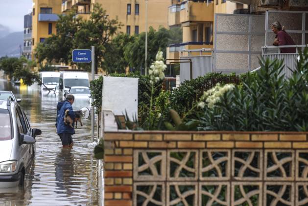 The Valencian Regional Government is preparing a lockdown order for the southern coast of Valencia and the northern coast of Alicante due to the rains. A man walks through a flooded area with a dog on October 19, 2026, in Guardamar de la Safor, Valencia, Valencian Community, Spain. The Valencian Regional Government is preparing a lockdown order for the southern coast of Valencia and the northern coast of Alicante in response to the emergency declared due to the rains brought by Storm Adam, as announced by the Regional Minister of Emergencies and the Interior early this morning, October 19, from the Emergency Coordination Center (CCE) October 19, 2026, Valencia, Valencian Community, Spain  Copyright: xRoberxSolsonax 7855284