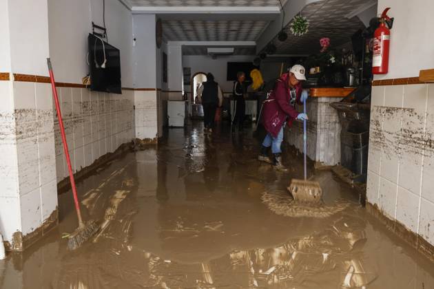 The Valencian Regional Government is preparing a lockdown order for the southern coast of Valencia and the northern coast of Alicante due to the rains. Several people are clearing mud from the streets while furniture they had to remove due to flooding caused by the heavy rains piles up, on October 19, 2026, in Els Poblets, Valencian Community, Spain. The Valencian Regional Government is preparing a lockdown order for the southern coast of Valencia and the northern coast of Alicante in response to the emergency declared due to the rains brought by Storm Adam, as announced by the Regional Minister of Emergencies and the Interior early this morning, October 19, from the Emergency Coordination Center (CCE) October 19, 2026, Valencia, Valencian  Copyright: xRoberxSolsonax 7855648