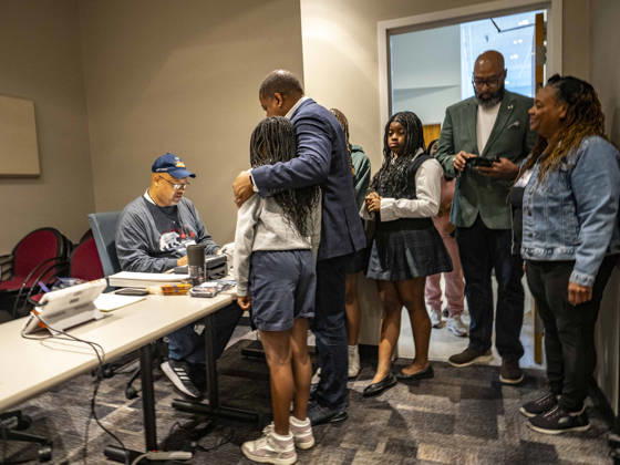 October 19, 2026, Little Rock, Arkansas, USA: Poll worker JERRY SAXTON checks in Democratic Congressional candidate CHRIS JONES so he can cast his ballot on the first day of early vote in Arkansas.Jones puts his arm around his daughter, JASMINE JONES as he waits. Jones is running for the seat now held by Rep. French Hill (R-AR). Should Jones win, he will be the first Black person Arkansas sends to Congress. Little Rock USA - ZUMAd155 20261019_znp_d155_028 Copyright: xSuexDorfmanx