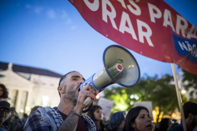 (261021) -- LISBON, Oct. 21, 2026 -- A man attends a rally at Praca D. Pedro IV in Lisbon, Portugal, Oct. 20, 2026. Portuguese police arrested 55 protesters for civil disobedience, and two people were injured in the early hours of Tuesday, as security forces moved to dismantle camps of housing rights protesters in public squares in Lisbon and Porto. (Photo by Xinhua) PORTUGAL-LISBON-RALLY-PROTESTERS CarlosxCosta 