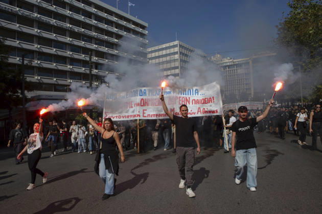 Athens Greece Living Costs Protest Protesters carry flares and a banner reading Free Public Education during a march in Athens, Greece on October 21, 2026. Students and other demonstrators marched through central Athens to protest rising living costs and economic pressures. Organizers say the concerns raised by participants echo grievances voiced during recent demonstrations in France. Athens Attica Greece Copyright: xElvisxTakahashixMantellox