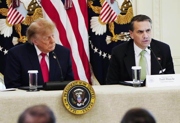 President Donald Trump (L) and Attorney General Todd Blanche attend a roundtable discussion on cybercrime in the East Room of the White House in Washington, DC on Wednesday, October 21, 2026. The discussion focuses on combatting foreign-based organized crime targeting Americans online and federal seizures of fraudulent crypto and scam websites.  WAP20261021907 BONNIExCASH