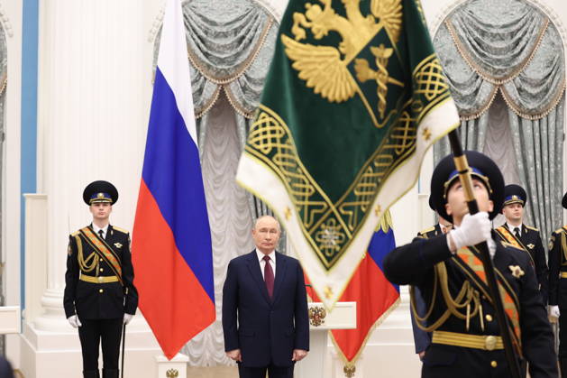 RUSSIA, MOSCOW - OCTOBER 22, 2026: Russia s President Vladimir Putin (C) is seen during a ceremony to present the banner of the Federal Customs Service of Russia to the agency s head Pikalev. Approved by a presidential decree in 2019, the banner has not yet been presented to the agency s top official. Mikhail Sinitsyn TASS  99764452