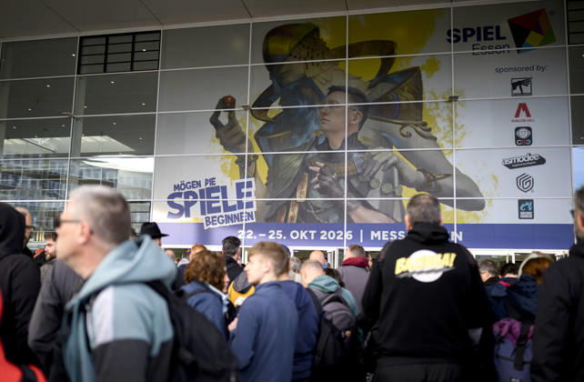 Visitors wait in front of the East Entrance; a rush of people; behind them, the SPIEL 26 logo; on October 22, 2026, at the SPIEL Essen trade show, held from October 22–25, 2026, in Essen, Germany, at the Grugahalle