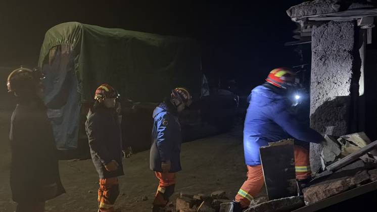 (261023) -- NAGQU, Oct. 23, 2026 -- Firefighters inspect an earthquake-hit village in Baqen County of Nagqu City in southwest China s Xizang Autonomous Region, on Oct. 23, 2026. Sixteen people were killed and 32 others injured after a 7.0-magnitude earthquake struck Baqen County of Nagqu City in southwest China s Xizang Autonomous Region at 10:33 p.m. Thursday (Beijing Time), according to the city s emergency management bureau. As of 2:25 a.m. Friday, 11 of the injured were in serious condition while 21 sustained minor injuries. Over 300 houses collapsed. The damage caused by the quake is being further evaluated, and disaster relief work is underway. More than 300 police officers have been dispatched to the epicenter for relief wor 
