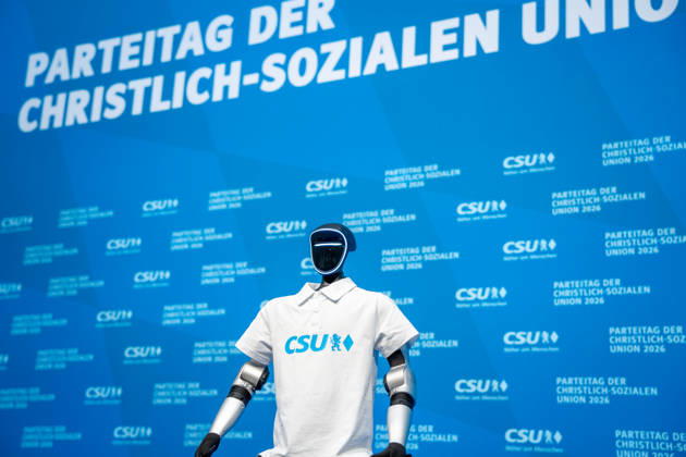 Munich, Bavaria, Germany October 23, 2026: The 2026 party convention of the CSU (Christian Social Union) at the Munich Trade Fair Center. The Unitree G1 humanoid robot from the Chinese manufacturer Unitree Robotics, wearing a white CSU polo shirt