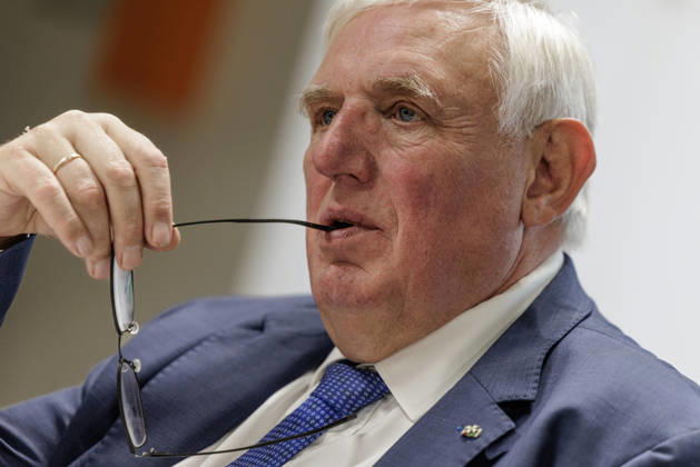 Karl Josef Laumann (CDU), Minister of Labor and Social Affairs for North Rhine-Westphalia, held the arm of his glasses in the corner of his mouth on October 23, 2026, during a WVS business breakfast at the Caritas Emstor Workshops (WfbM) in Rheine, North Rhine