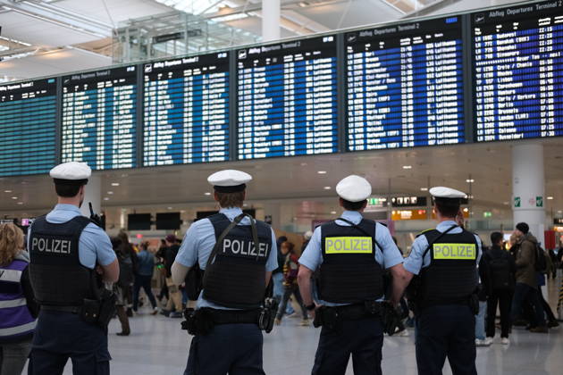 Protest at Munich Airport against planned deportation terminal MUNICH, GERMANY - OCTOBER 24: German federal police officers stand inside Munich Airport looking towards the departures board in Munich, Germany on October 24, 2026. Officers were deployed at the airport as protesters rallied against a planned deportation terminal at the site. Merve Goettl Anadolu Munich Germany. Editorial use only. Please get in touch for any other usage.  Copyright: x2026xAnadoluxMervexGoettlx