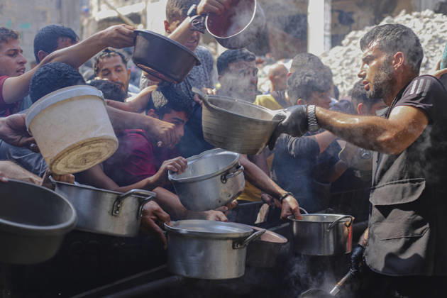 Gaza Palestinians Food Shortages 2026 Palestinians press toward a charity kitchen carrying pots and bowls to receive hot food in Jabalia Refugee Camp, northern Gaza Strip, Palestine, on October 24, 2026. Community kitchens remain a key source of food in Gaza, where UN humanitarian agencies reported cuts to cooked-meal distributions in October because of funding shortages. Jabalia Gaza Strip Palestinian Territories Copyright: xRamezxHabboubx