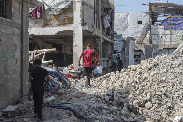Gaza Palestinians Food Shortages 2026 Palestinian residents walk through a rubble-strewn street past heavily damaged buildings in Jabalia Refugee Camp, northern Gaza Strip, Palestine, on October 24, 2026. The UN reports that damaged infrastructure, displacement and shortages of basic supplies continue to affect residents of Gaza, while funding shortages have reduced food assistance. Jabalia Gaza Strip Palestinian Territories Copyright: xRamezxHabboubx