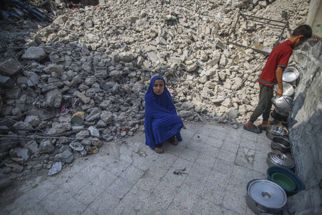 Gaza Palestinians Food Shortages 2026 A Palestinian child sits beside rubble from destroyed buildings while another child stands nearby in Jabalia Refugee Camp, northern Gaza Strip, Palestine, on October 24, 2026. The UN reports that damaged infrastructure, displacement and shortages of basic supplies continue to affect residents of Gaza, while funding shortages have reduced food assistance. Jabalia Gaza Strip Palestinian Territories Copyright: xRamezxHabboubx