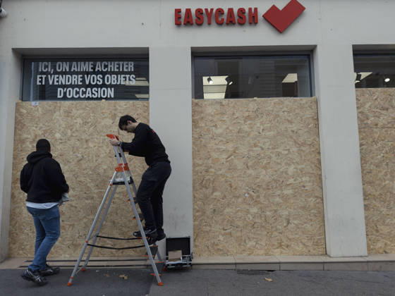 Lyon France Anti-Government Protest Men install wooden panels over the windows of a secondhand goods shop in Lyon, France, on October 24, 2026. Businesses in central Lyon took precautions amid concerns about further unrest following damage to shops during demonstrations the previous weekend. Lyon Rhone Alpes France Copyright: xAbolfazlxSalmanzadehx