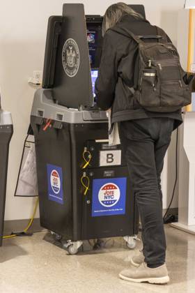 October 24, 2026, New York, New York, USA: A Lower Manhattan resident scans their ballot at the Borough of Manhattan Community College polling site in Tribeca on the first day of early voting for the midterm elections in New York. New York USA - ZUMAr174 20261024_znp_r174_029 Copyright: xGinaxMxRandazzox