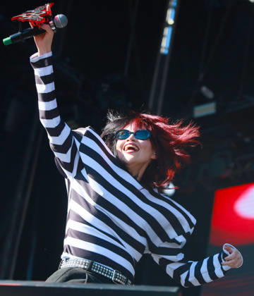 October 24, 2026, Tijuana, Baja California, Mexico: Mexican alternative pop singer BRUSES holds up her microphone with a red custom emblem while performing live on stage during the Tecate Peninsula 2026 music festival at Explanada Estadio Caliente in Tijuana, Baja California, Mexico, October 24, 2026. She wears sunglasses and a black-and-white striped long-sleeve top. Tijuana Mexico - ZUMAm311 20261024_zip_m311_007 Copyright: xAlbertoxMartinezx