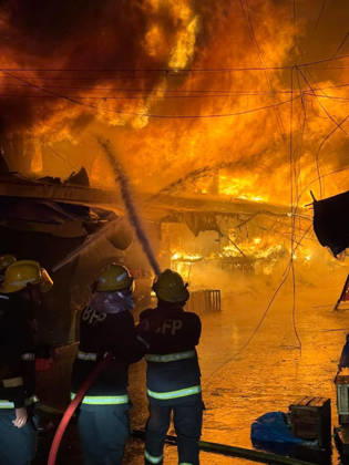 (261025) -- SORSOGON, Oct. 25, 2026 -- Firefighters try to put out a fire at a public market in Sorsogon city of southern Luzon, the Philippines, on Oct. 25, 2026. Five people have been confirmed dead after a fire in a public market here on Saturday night, local media reported Sunday. ( Handout via Xinhua) (SpotNews) PHILIPPINES-SORSOGON-PUBLIC MARKET-FIRE ThexPhilippines xBureauxofxFirexProtection 