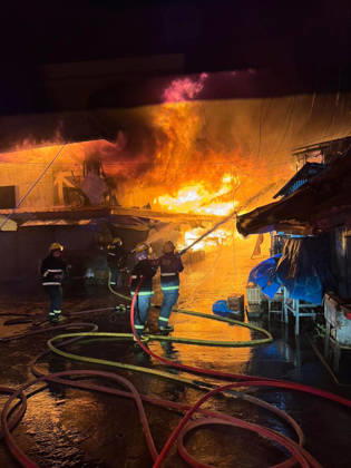 (261025) -- SORSOGON, Oct. 25, 2026 -- Firefighters try to put out a fire at a public market in Sorsogon city of southern Luzon, the Philippines, on Oct. 25, 2026. Five people have been confirmed dead after a fire in a public market here on Saturday night, local media reported Sunday. ( Handout via Xinhua) (SpotNews) PHILIPPINES-SORSOGON-PUBLIC MARKET-FIRE ThexPhilippines xBureauxofxFirexProtection 