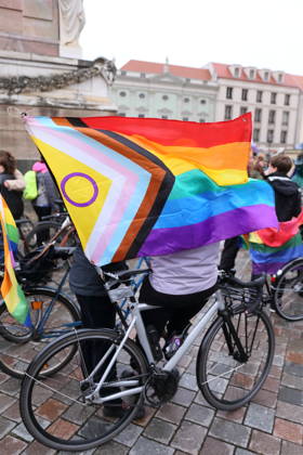 Protesters stand with a rainbow flag on the Alter Markt during Bike Pride in Potsdam, October 24, 2026 Bike Pride Potsdam
