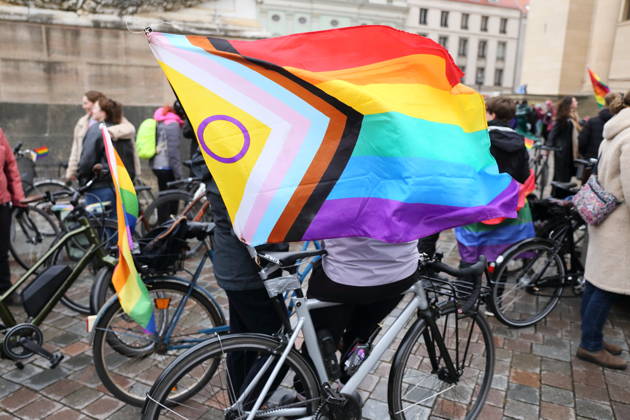 Protesters stand with a rainbow flag on the Alter Markt during Bike Pride in Potsdam, October 24, 2026 Bike Pride Potsdam