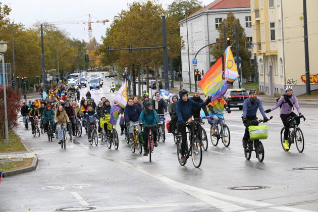 Protesters ride down Friedrich Engels Street waving rainbow flags during Bike Pride in Potsdam, October 24, 2026 Bike Pride Potsdam