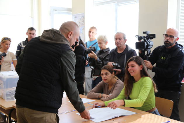 (261025) -- SOFIA, Oct. 25, 2026 -- A Bulgarian citizen registers for voting during the presidential election at a polling station in Sofia, Bulgaria, Oct. 25, 2026. Bulgarians went to the polls on Sunday to elect their next president. As many as 6.59 million voters are eligible to choose from 27 candidates, including incumbent President Iliana Iotova, according to the country s Central Election Commission. Polling stations across the country opened at 7:00 a.m. local time (0500 GMT) and are scheduled to close at 8:00 p.m. The first exit polls may be released immediately after voting ends, while the official results must be announced no later than Tuesday evening. ) BULGARIA-SOFIA-PRESIDENTIAL ELECTION-VOTING LinxHao 