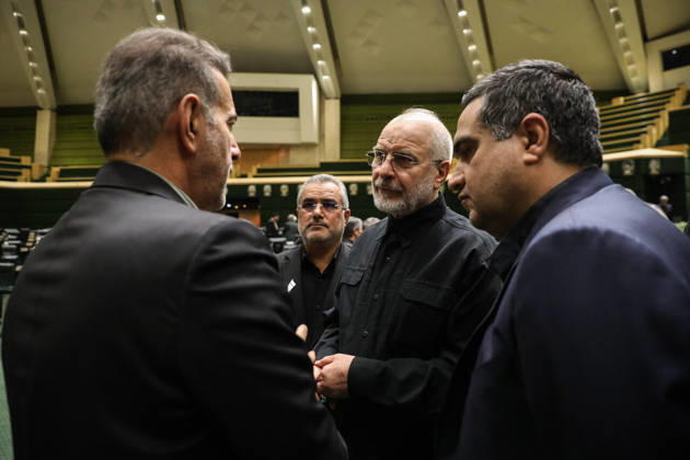 October 25, 2026, Tehran, Iran: Mohammad Bagher Ghalibaf speaks with two suited men standing close to him among the green seats of parliament at the Islamic Consultative Assembly in Tehran, Iran, on October 25, 2026. Parliamentary reports said more than two-thirds of lawmakers joined the October 25 open sitting of the Islamic Consultative Assembly, attending either in person or remotely. Tehran Iran - ZUMAi98_ 20261025_zih_i98_031 Copyright: xIcanax