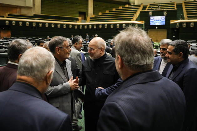 October 25, 2026, Tehran, Iran: Mohammad Bagher Ghalibaf exchanges greetings with a small circle of suited men in the parliamentary chamber at the Islamic Consultative Assembly in Tehran, Iran, on October 25, 2026. The Iranian parliament held a hybrid open sitting, with some lawmakers attending in the Tehran chamber and others participating remotely, according to parliamentary reports. Tehran Iran - ZUMAi98_ 20261025_zih_i98_033 Copyright: xIcanax