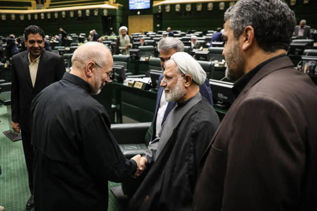 October 25, 2026, Tehran, Iran: Mohammad Bagher Ghalibaf shakes hands with a gray-haired cleric as other men stand around them in the parliament chamber at the Islamic Consultative Assembly in Tehran, Iran, on October 25, 2026. Parliamentary reports said more than two-thirds of lawmakers joined the October 25 open sitting of the Islamic Consultative Assembly, attending either in person or remotely. Tehran Iran - ZUMAi98_ 20261025_zih_i98_035 Copyright: xIcanax
