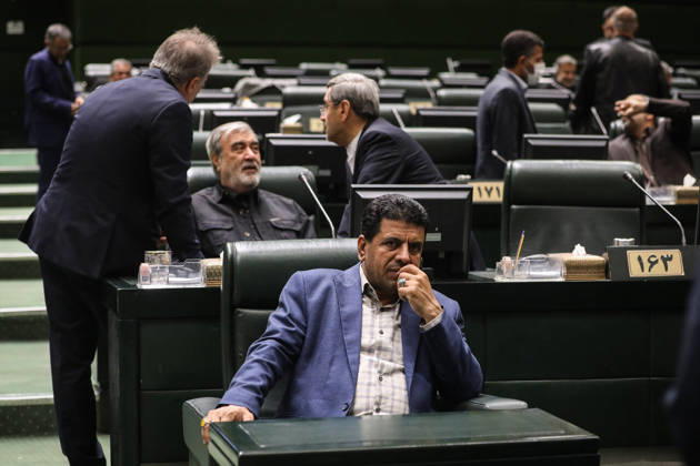 October 25, 2026, Tehran, Iran: A seated Iranian lawmaker rests his hand against his face while men converse across the rows behind him at the Islamic Consultative Assembly in Tehran, Iran, on October 25, 2026. Speaker Mohammad Bagher Ghalibaf chaired the October 25 session, which combined physical attendance at the Islamic Consultative Assembly with participation by video link. Tehran Iran - ZUMAi98_ 20261025_zih_i98_040 Copyright: xIcanax